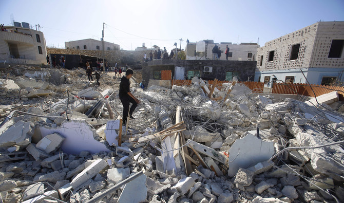 Palestinians looks at houses destroyed by the Israeli military in the village of Beit Kahil near the West Bank city of Ramallah.