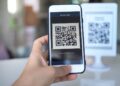 Customer scanning a UPI QR code with a smartphone to make a small payment