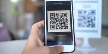 Customer scanning a UPI QR code with a smartphone to make a small payment