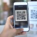 What Is UPI Lite Limit in 2026? Wallet, Payment Caps and Setup Customer scanning a UPI QR code with a smartphone to make a small payment