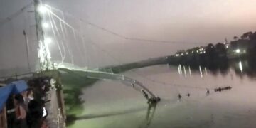 Scores of people fall into river after suspension bridge collapses in Gujarat’s Morbi
