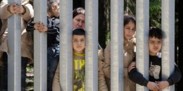 Migrants with children stuck at Poland’s border wall; activists say Belarus won’t let them turn back
