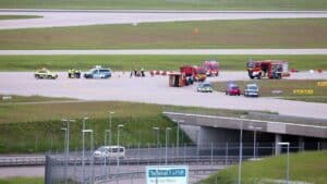 Climate activists glue themselves to runway at Munich airport in Germany