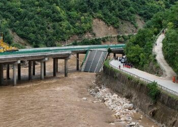 11 dead and dozens missing after a highway bridge in China crumbles in flooding