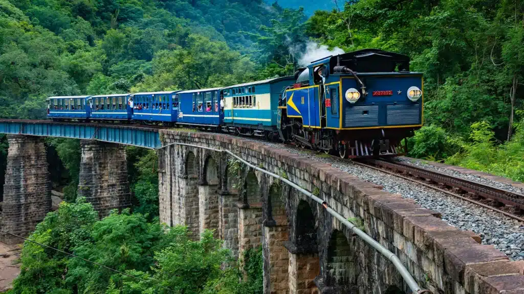 Why Are Train Coaches Different Colours? ICF vs LHB Explained Red LHB coaches of an Indian express train running on the tracks