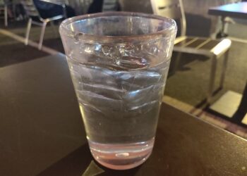 A glass of drinking water on a table