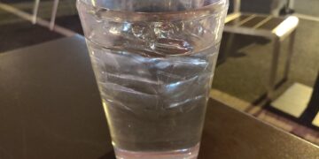 A glass of drinking water on a table