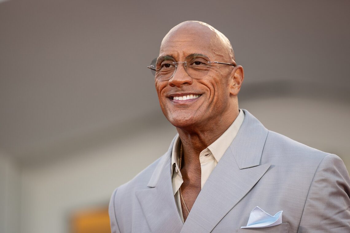 Top 10 Richest WWE Wrestlers of 2026: Net Worth Ranked Dwayne "The Rock" Johnson smiling at a film premiere