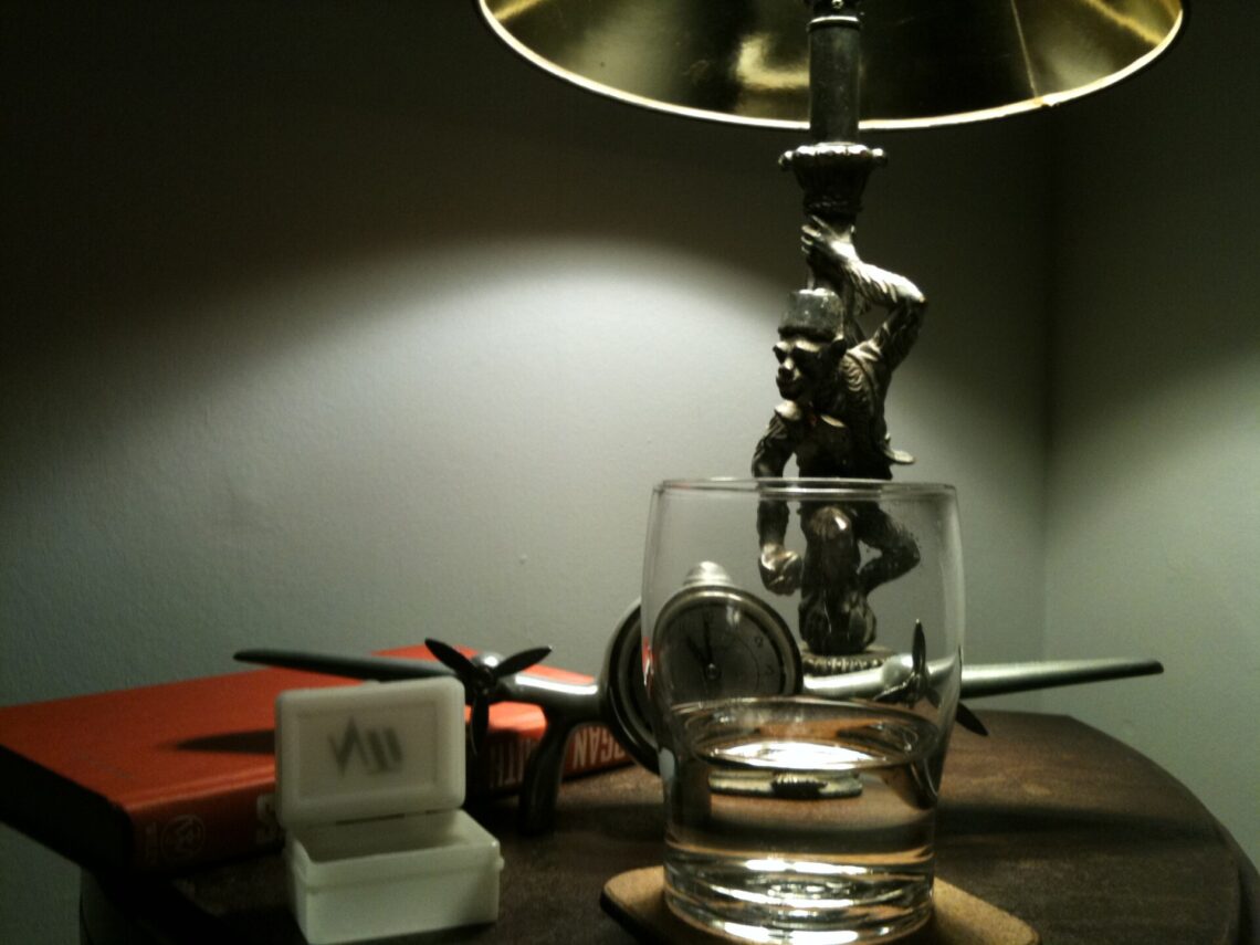 Sleep Hygiene: 10 Habits That Help You Sleep Better A bedside lamp and nightstand in a dark bedroom