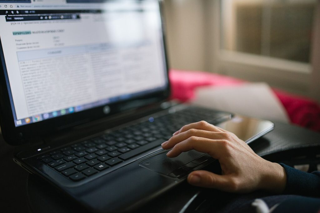 A person editing a document on a laptop using a free PDF editor