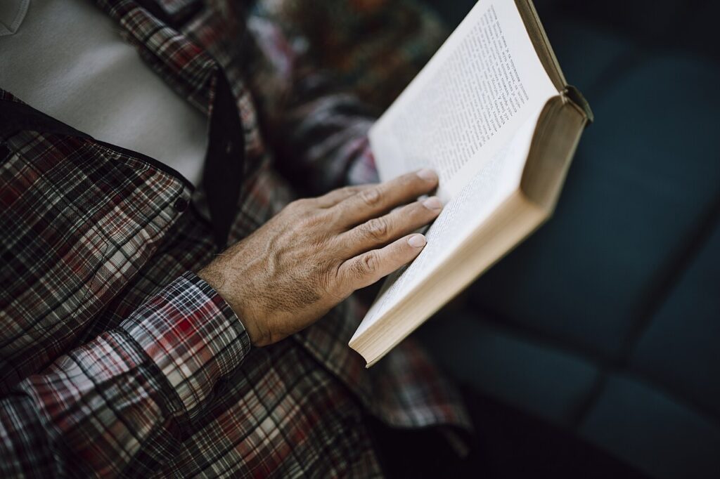 A person reading a book, one of the everyday habits linked to a sharper mind