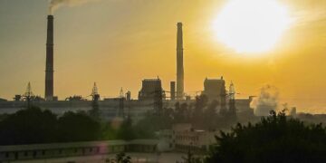 Hazy sunrise over Delhi with smoke from a power plant clouding the sky