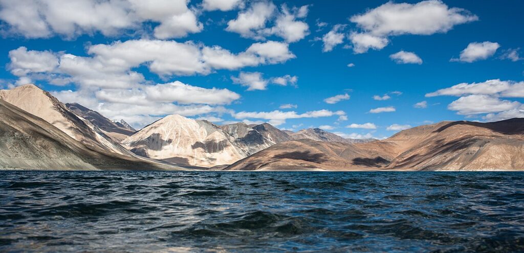Blue waters of Pangong Tso lake surrounded by mountains in Ladakh