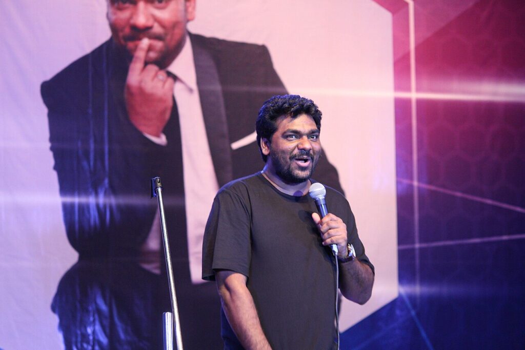 8 Best Stand Up Comedians in India Who Rule the Stage in 2026 Indian stand up comedian Zakir Khan performing on stage