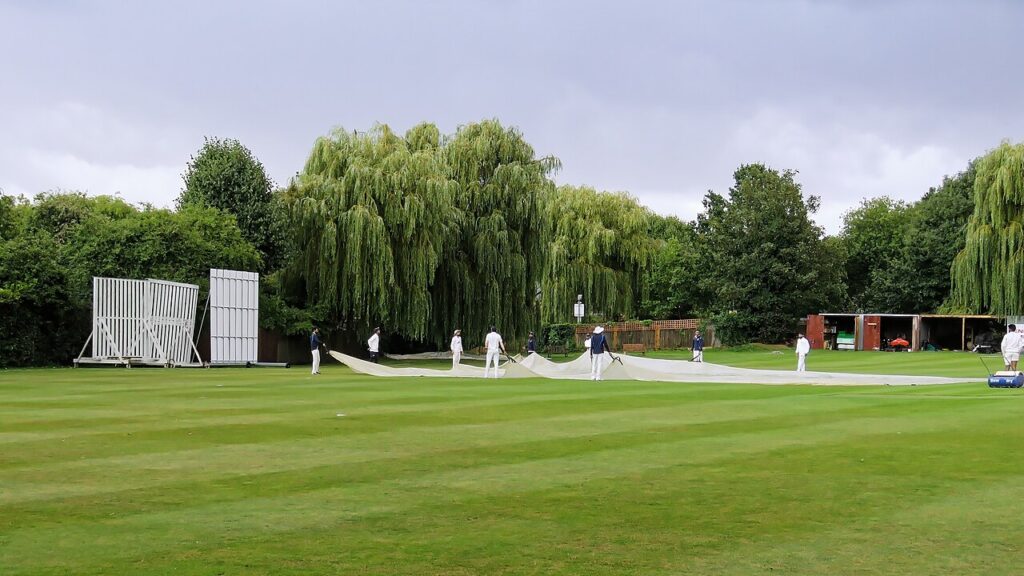 DLS Method in Cricket Explained: How Rain-Hit Targets Are Set Ground staff covering a cricket pitch at Crouch End, London