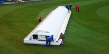 Hover cover protecting the pitch at Old Trafford cricket ground during rain