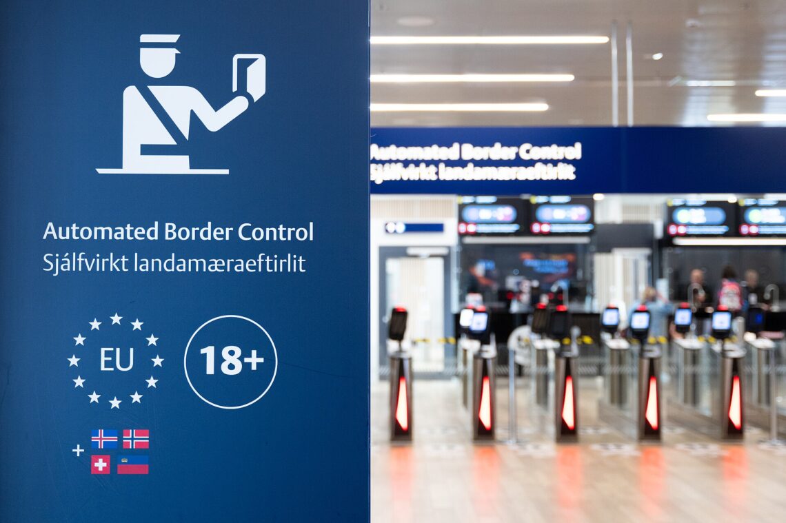 EU Entry Exit System Explained: EES Rules, Dates and ETIAS Traveller holding a passport at an airport border control desk in Europe