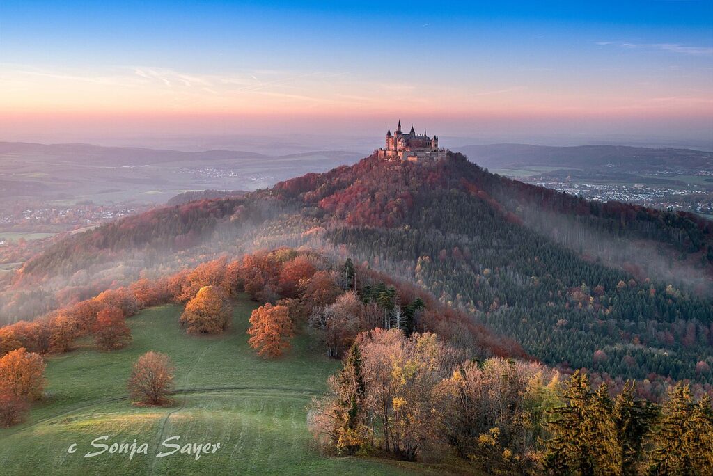 The World's Top 5 Locations For A Perfect Skydive In 2026 Hohenzollern Castle on its hilltop in Baden-Württemberg, Germany, rising above morning mist