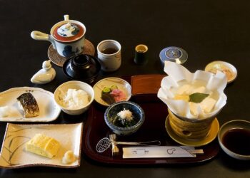Traditional Japanese breakfast with grilled fish, rice, miso soup, tofu and pickles at a Kyoto inn