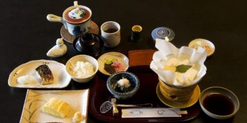 Traditional Japanese breakfast with grilled fish, rice, miso soup, tofu and pickles at a Kyoto inn