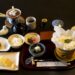 Traditional Japanese breakfast with grilled fish, rice, miso soup, tofu and pickles at a Kyoto inn