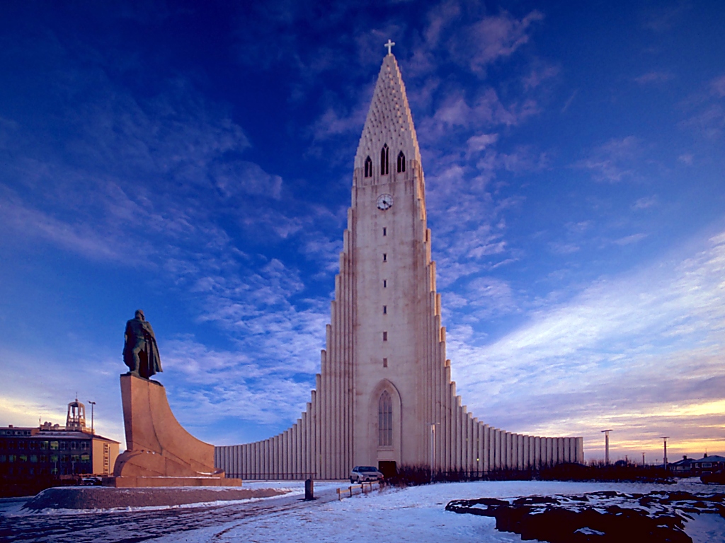7 Best Instagrammable Places In Reykjavik For 2026 Travellers Hallgrímskirkja church tower rising above the rooftops of Reykjavik, Iceland