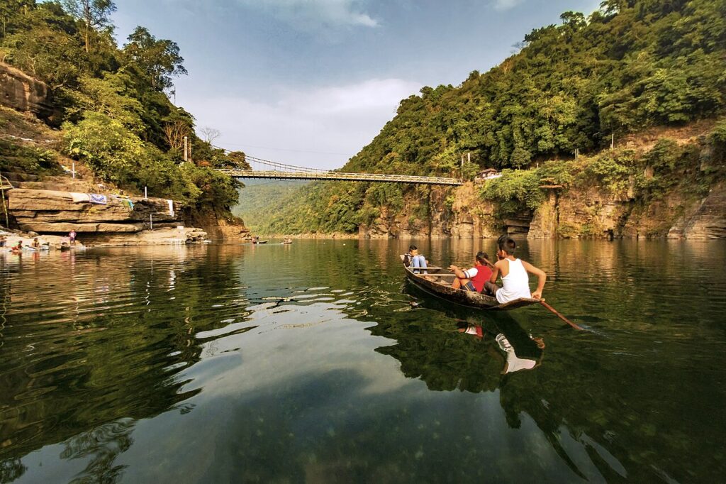 Meghalaya Travel Guide: Root Bridges, Best Time and Route Clear waters of the Umngot river at Dawki, Meghalaya, with boats