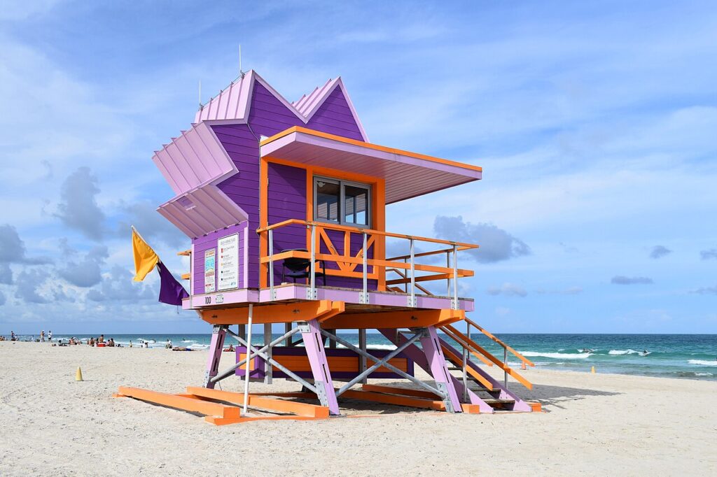7 Best Beaches in Miami: From South Beach to Cape Florida A colourful lifeguard tower on South Beach in Miami with the Atlantic Ocean behind it