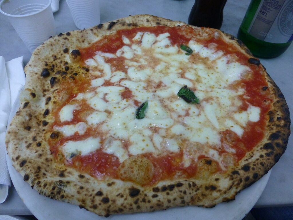 Pizza Margherita with tomato, mozzarella and basil, a must try food from Italy