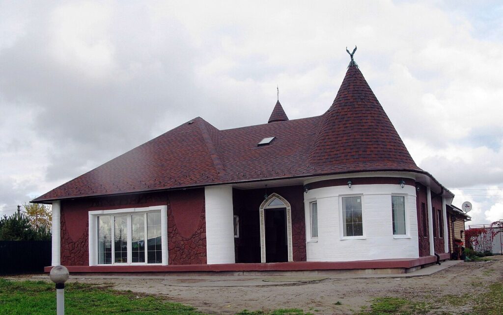 A concrete 3D printer laying walls of a house layer by layer